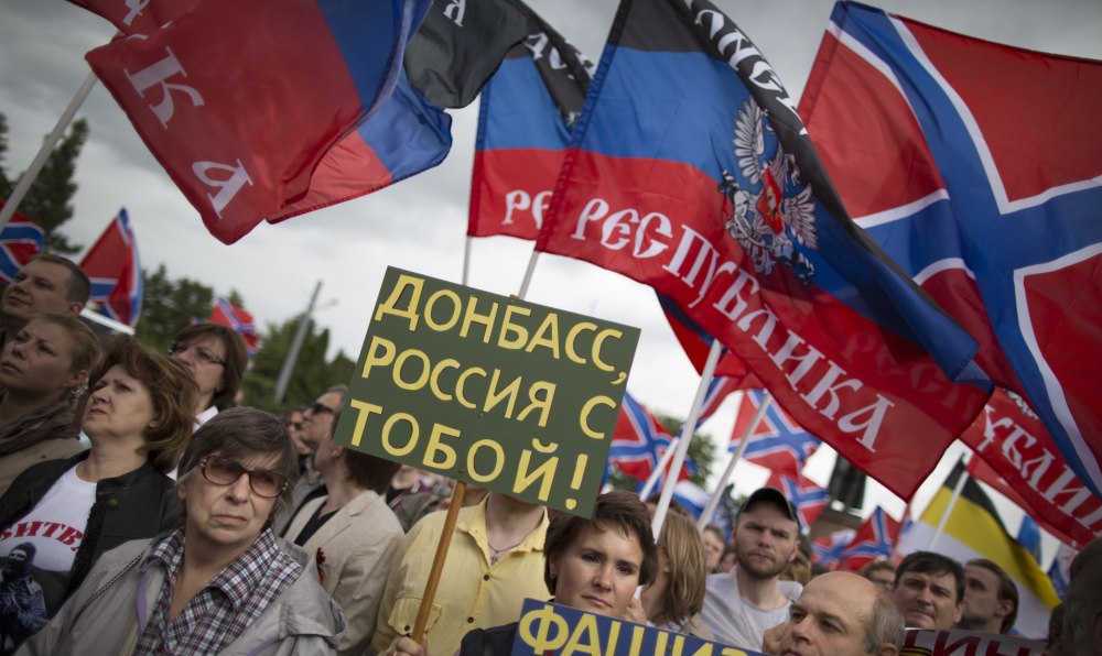People attend a rally for the pro-Russian Donetsk Peoples Republic in Moscow on Wednesday. Russia is supplying humanitarian aid to eastern Ukraine with the aid of militia.