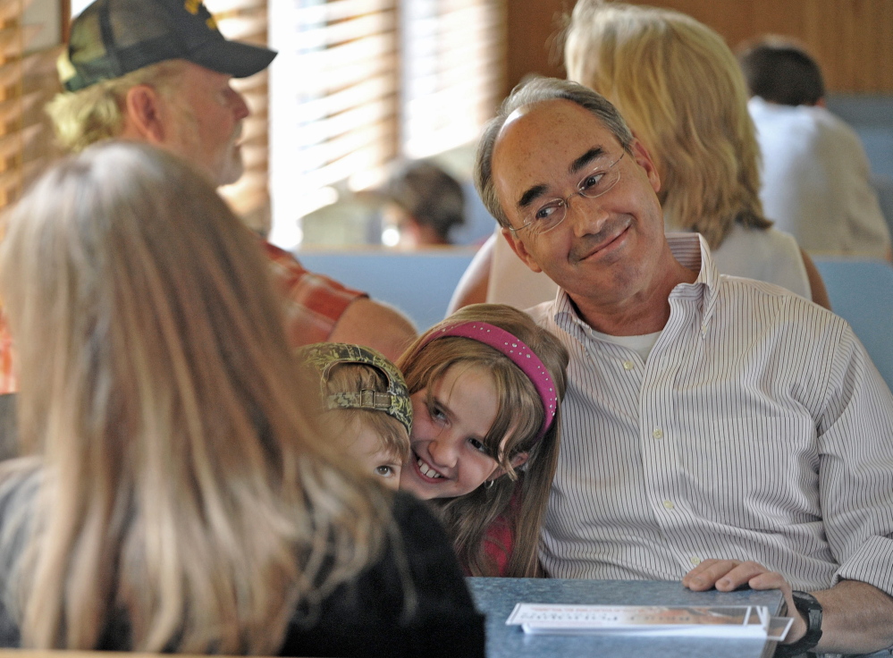 Bruce Poliquin, right, the Republican candidate for Maine’s 2nd District seat, talks with Laura Parker, back to camera, while sitting next to her children Wednesday at the House of Pizza in Oakland.