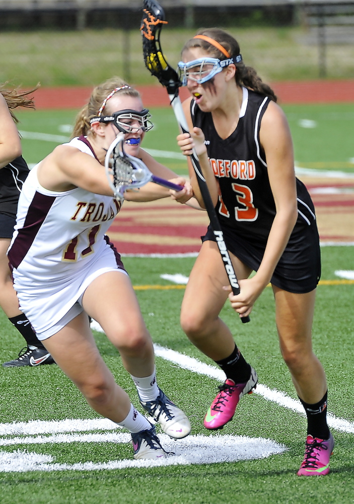 Melissa Huot, right, of Biddeford tries to get past the defense of Tatum Leclair of Thornton Academy during the Trojans’ 5-1 win on Wednesday.