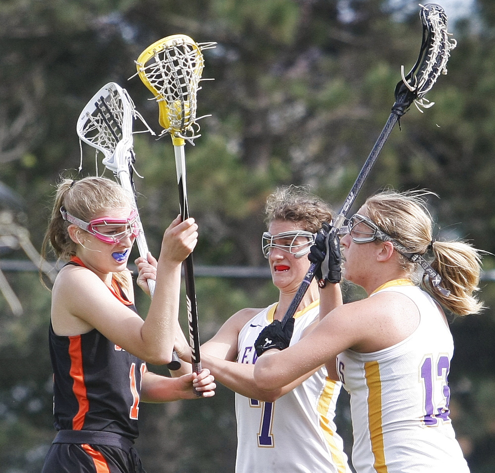 Brunswick’s Sarah Ferdinand gets no open space with Cheverus defenders Elyse Caiazzo, center, and Alex Logan converging during an Eastern Class A girls’ lacrosse quarterfinal game on Wednesday. Cheverus won 20-5 to advance to the semifinals. 