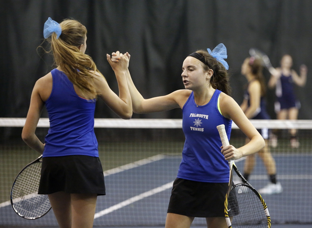 Kate Kelley, left, and Katie Ryan of Falmouth celebrate a point during the doubles match in the Class A Western tennis finals on Thursday. They won their match 6-3, 6-0.