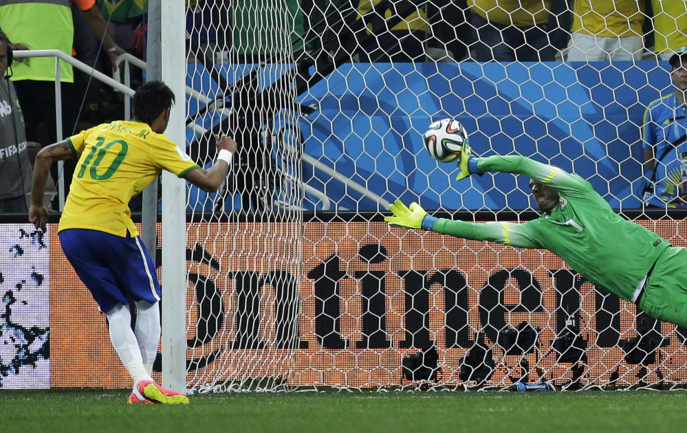 Brazil’s Neymar, left, scores his sides second goal from the penalty spot during the group A World Cup soccer match between Brazil and Croatia, the opening game of the tournament, in the Itaquerao Stadium in Sao Paulo, Brazil, Thursday, June 12, 2014.