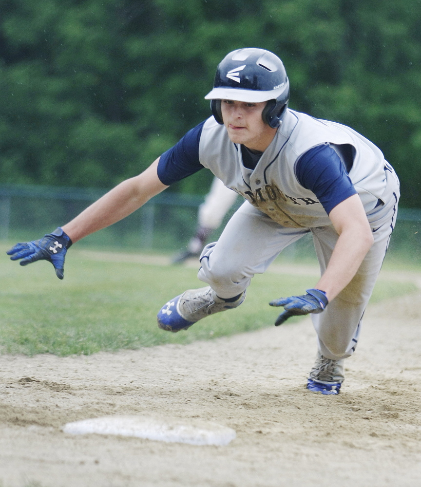 Cody Cook of 10th-seeded Yarmouth dives back to first base on a pickoff attempt Thursday in a 4-0 loss to second-seeded Greely in the Western Class B quarterfinal at Cumberland. Greely will be home against Poland in the semifinals.