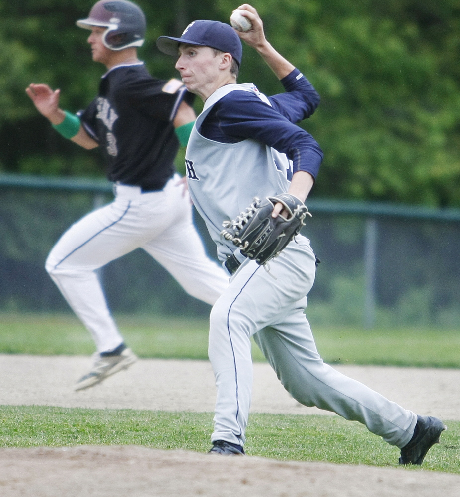 Yarmouth third baseman Connor Lainey throws home for the out as Greely’s Austin Nowinski runs to third during Greely’s Western B quarterfinal win on Thursday in Cumberland.
