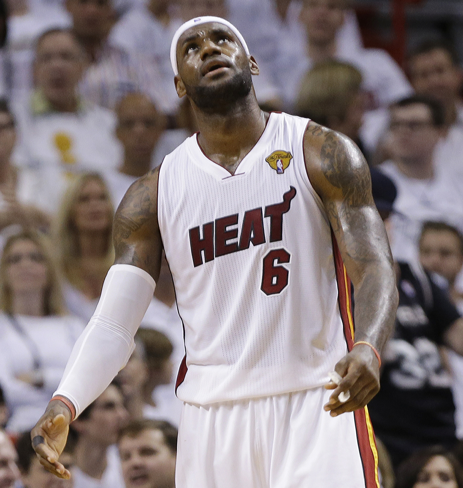Miami’s LeBron James can only stare at the scoreboard as his team is dominated at home by the Spurs.