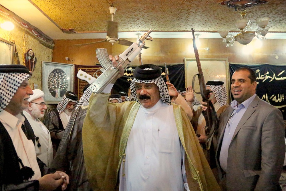 Iraqi Shiite tribal leaders chant slogans against the al-Qaida-inspired Islamic State of Iraq and the Levant (ISIL), in Baghdad on Friday. The leaders met in Sadr City and declared their readiness to take up arms against the al-Qaida inspired group.
