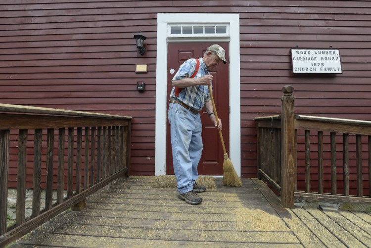 Volunteer Alfred Carlson, a member of Friends of the Alfred Shaker Museum, sweeps the front steps at the museum. Shawn Patrick Ouellette/Staff Photographer
