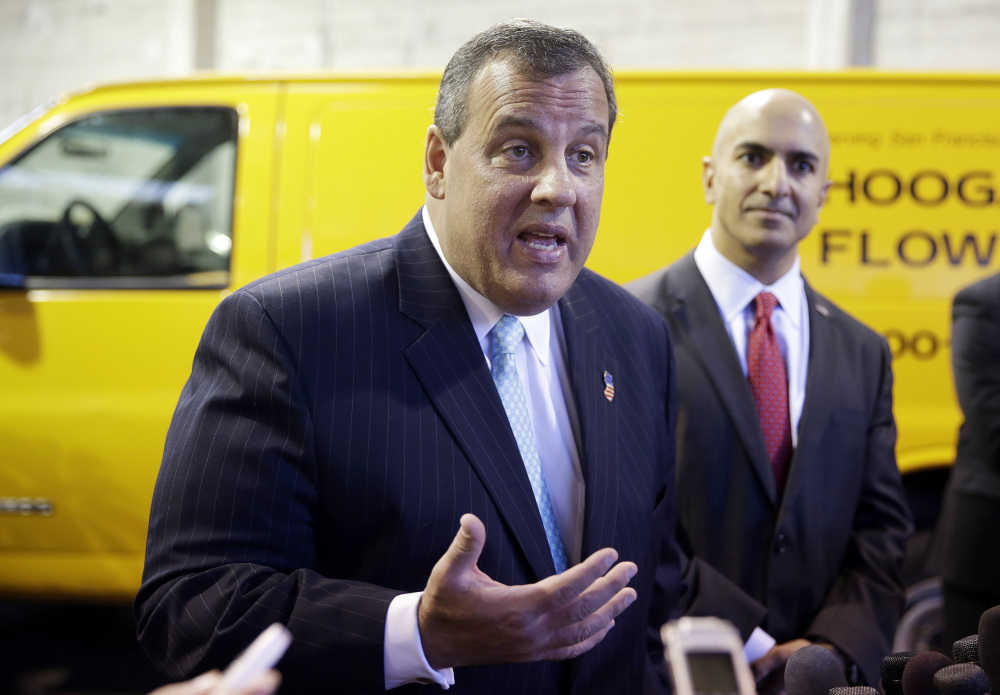 New Jersey Gov. Chris Christie, left, answers questions as California gubernatorial candidate Neel Kashkari, right, looks on during a visit to Hoogasian Flowers Friday, June 13, 2014, in San Francisco.