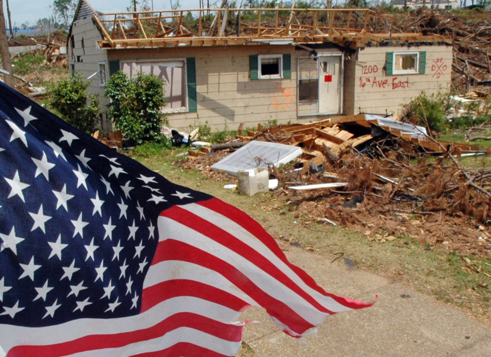 A flag flies over the remains of a tornado-ravaged neighborhood in Tuscaloosa, Ala., in 2001. Oklahoma and Kansas may have the reputation as tornado hot spots, but Florida and the rest of the Southeast are far more vulnerable to deadly twisters, a new analysis shows.