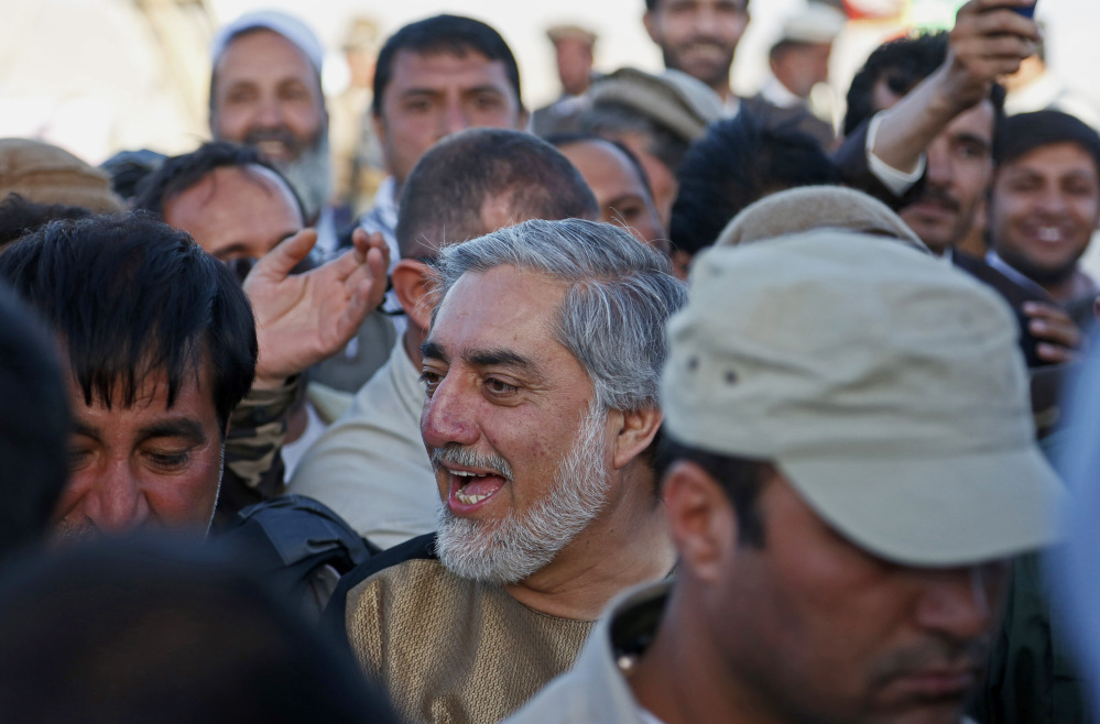 In this photo taken Monday, June 9, 2014, Afghanistan presidential candidate Abdullah Abdullah greets with his supporters during a campaign rally in the Paghman district of Kabul, Afghanistan. With fears of violence high, Afghanistan braced for a final election on Saturday to choose a new president to replace the only leader the nation has known since the Taliban were ousted and guide the transition to a country that will have to wean itself off near-total dependence on international aid after foreign combat troops withdraw at the end of this year. (AP Photo/Rahmat Gul)
