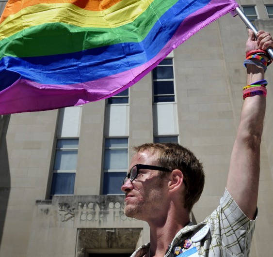 Gary Jones of Racine, Wis., holds a gay-pride flag in front of the Racine County Courthouse on Friday.