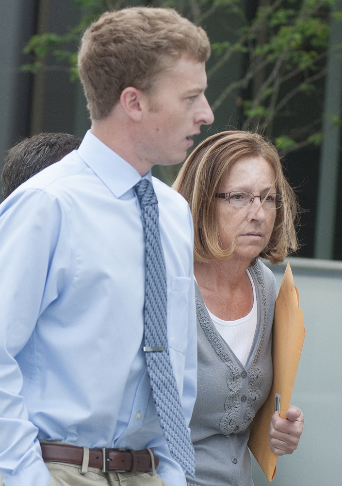 Carole J. Swan, former Chelsea selectwoman, with her younger son John Swan, as they enter the U.S. District Court building in Bangor Friday for her sentencing hearing on extortion, tax fraud and workers’ compensation fraud.