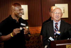 Former heavyweight boxing champion Evander Holyfield shows off the key to the city that was given to him by Portland Mayor Michael Brennan on Friday. Holyfield will attend a series of fights Saturday night at the Portland Expo.