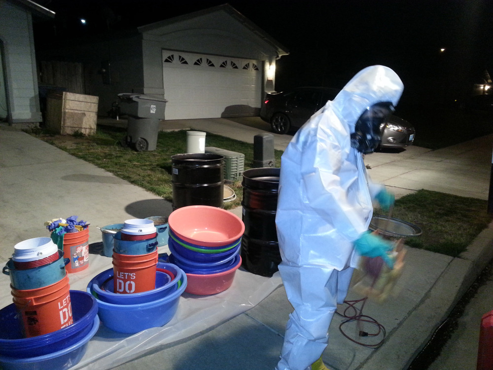 Jeff Davis, a hazardous materials specialist for PARC Environmental, cleans up a meth conversion lab inside a house in Madera, Calif. Authorities in California’s Central Valley say that in recent years they have begun to see more meth dissolved as liquid and put into tequila bottles or plastic detergent containers to smuggle it across the border from Mexico.