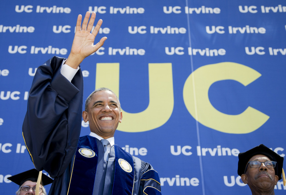 President Obama, with University of California, Irvine Chancellor Michael Drake, waves to the UCI graduating class at Angel Stadium in Anaheim, Calif., on Saturday.