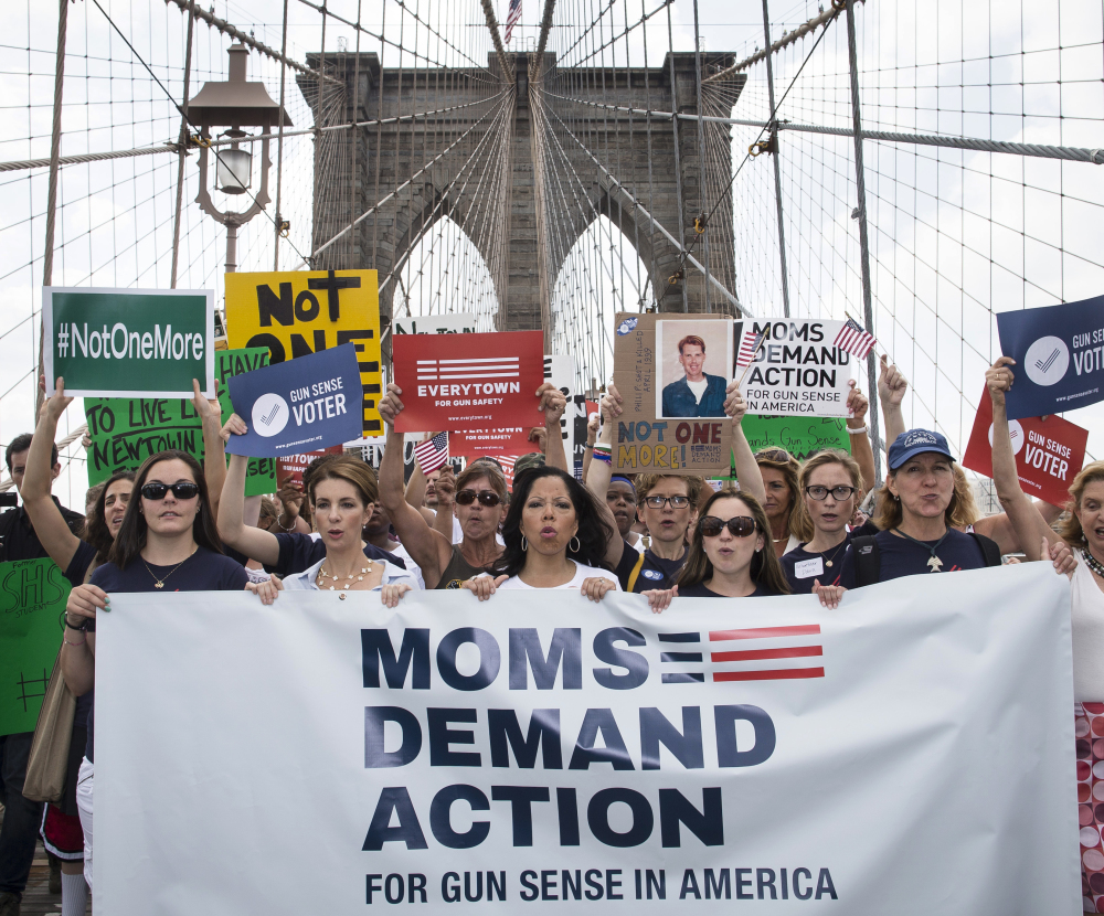 Hundreds of demonstrators march across the Brooklyn Bridge to call for tougher gun control laws Saturday. The protest included relatives of those slain in Newtown, Conn.