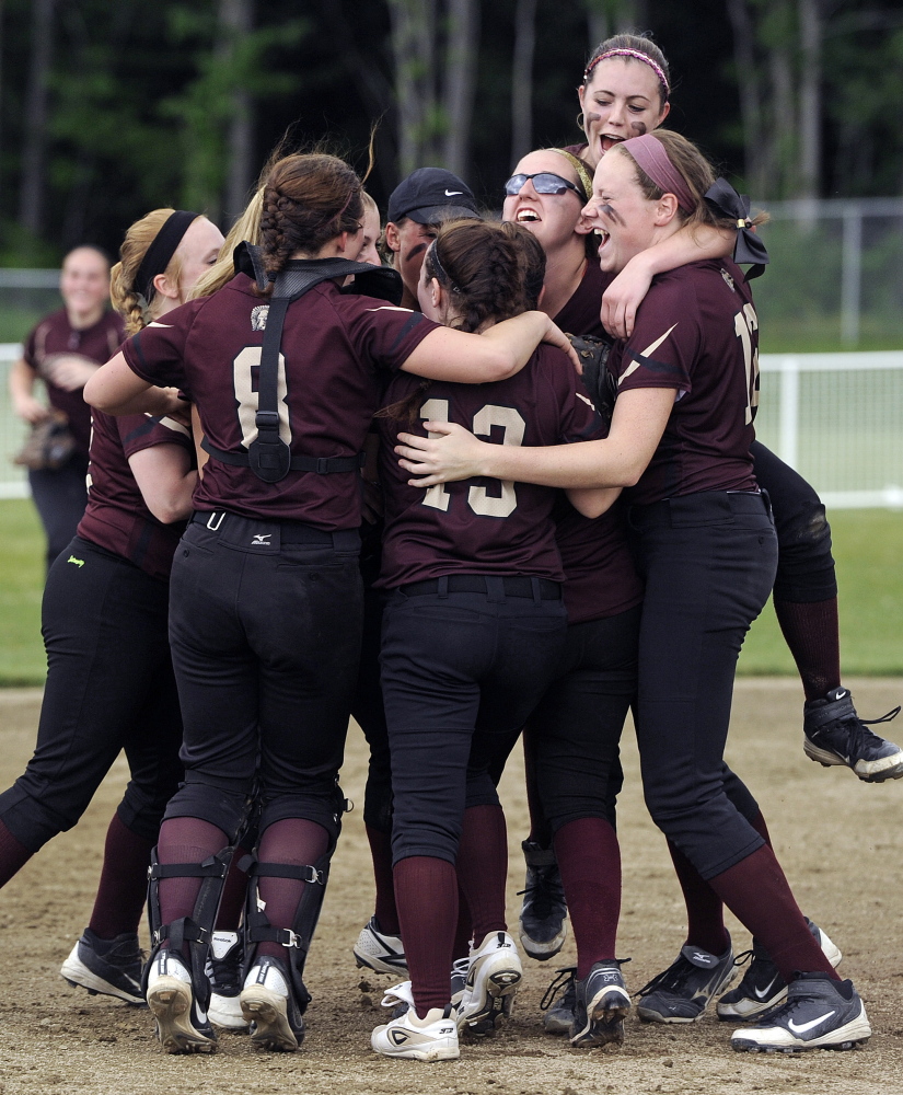 Thornton Academy players celebrates after they advanced to the Western Class A softball final with a 10-3 victory Saturday against Cheverus.
