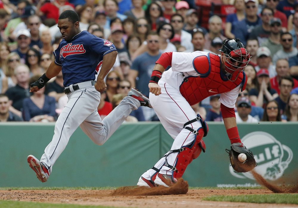 Michael Bourn of the Cleveland Indians scores as Red Sox catcher A.J. Pierzynski gets the throw on a double hit by Asdrubal Cabrera in the third inning at Fenway Park in Boston on Saturday.