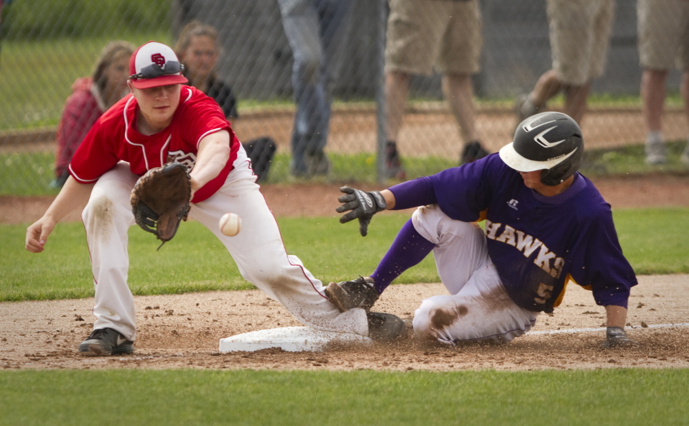Marshwood baserunner Zachary Quintal slides safely into third as South Portland third baseman Sam Solomon tries to handle the throw  during Class A semifinal game action at the Wainwright Complex in South Portland on June 14, 2014. 