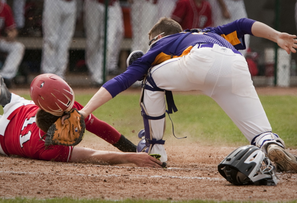 Marshwood catcher Luke Stankovich places a tag on Christopher Foley of South Portland to cut down a run in the fifth inning Saturday during Marshwood’s 3-1 victory in the Western Class A semifinals at South Portland.