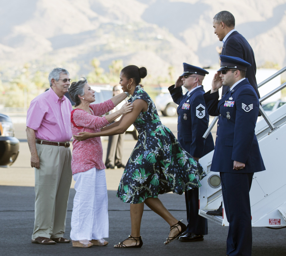 President Barack Obama and first lady Michelle Obama are greeted on the tarmac by Sen. Barbara Boxer, D-Calif., second from left, and her husband, Stewart Boxer, left, on Friday in Palm Springs, Calif.