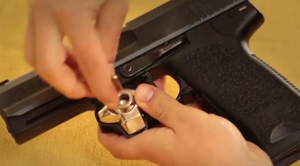 A Maine nonprofit is giving away gun trigger locks like this one, distributing 5,000 of the devices at no charge through police departments around Maine.