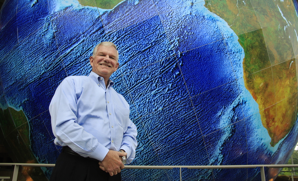 DeLorme Publishing CEO Michael Heffron, standing near the giant revolving Earth in the window of its Yarmouth headquarters, says “we’re going to protect our reputation” in the patent case appeal.