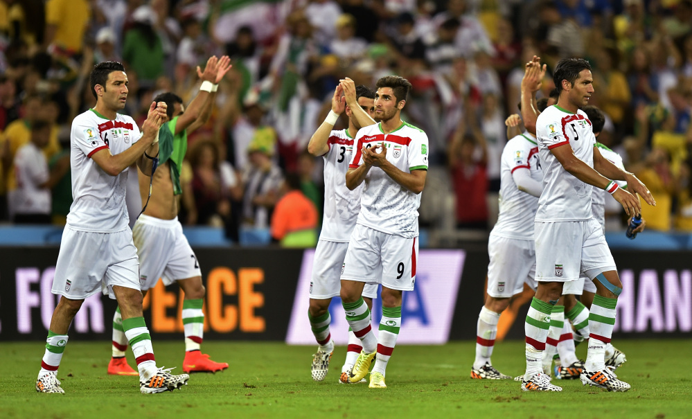 Iranian players applaud the crowd after the group F World Cup soccer match between Iran and Nigeria at the Arena da Baixada in Curitiba, Brazil, Monday, June 16, 2014. The match ended in a 0-0 draw.