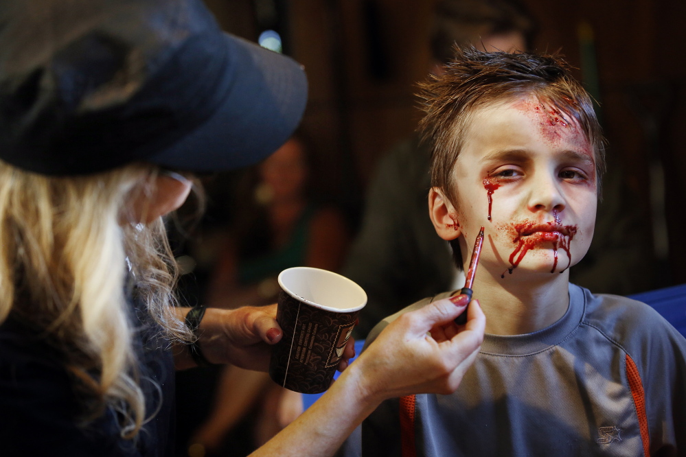 Derek Davis/Staff Photographer
Ozric Stewart, 7, of Yarmouth gets his hair and makeup done Monday before his scene in “Night of the Living Deb.”