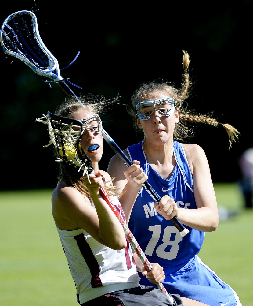 FREEPORT, ME - JUNE 16: Freeport's Courtney Broderick tries to keep the ball from Noa Sreden of Morse in girls lacrosse action Monday, June 16, 2014. (Photo by Shawn Patrick Ouellette/Staff Photographer)