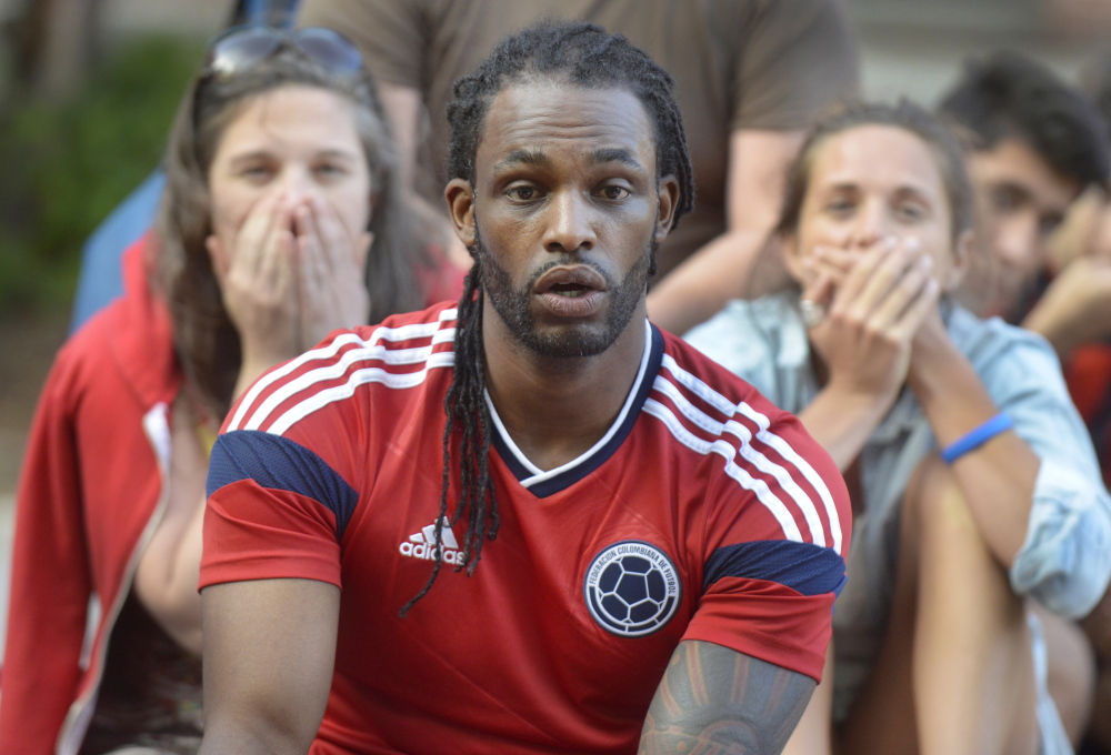 Anderson Arellano, a native of Colombia, reacts to a near-goal as Biz Wing, back left, and her sister Lexi Wing gasp during a public World Cup viewing Monday night in Congress Square Plaza. The crowd watched the United States beat Ghana 2-1.