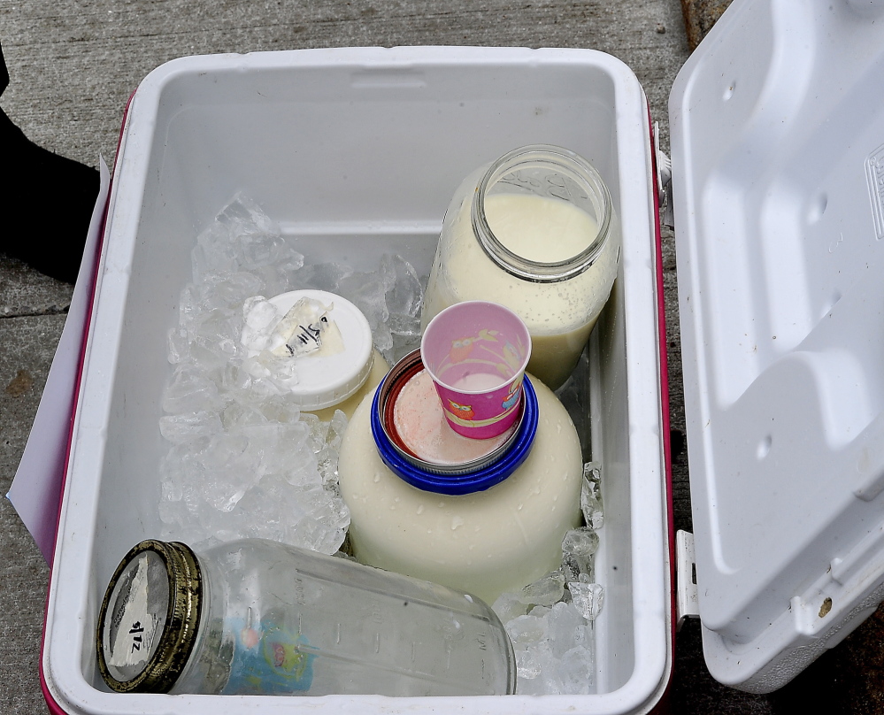 PORTLAND, ME - MAY 13: Raw cows milk and goats milk sit in a cooler to allow people to taste and enjoy it after Farmer Dan Brown joined demonstrators before his trial in Supreme Court. (Photo by Gordon Chibroski/Staff Photographer)