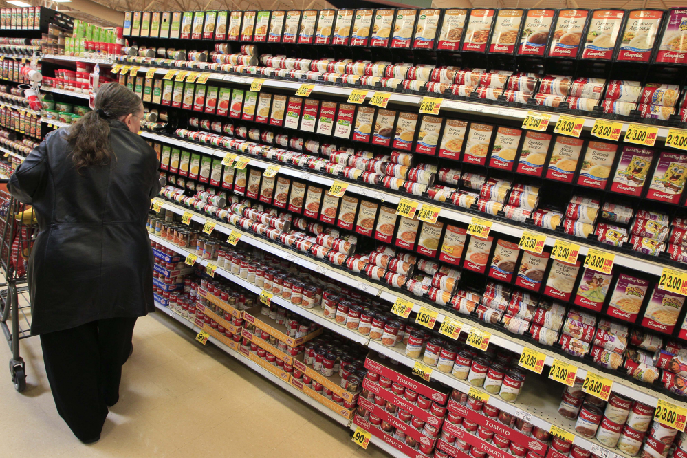 A shopper walks down the canned soup aisle at a grocery store in Cincinnati. Food companies and restaurants could soon face government pressure to make their foods less salty to try to prevent thousands of deaths each year from heart disease and stroke.