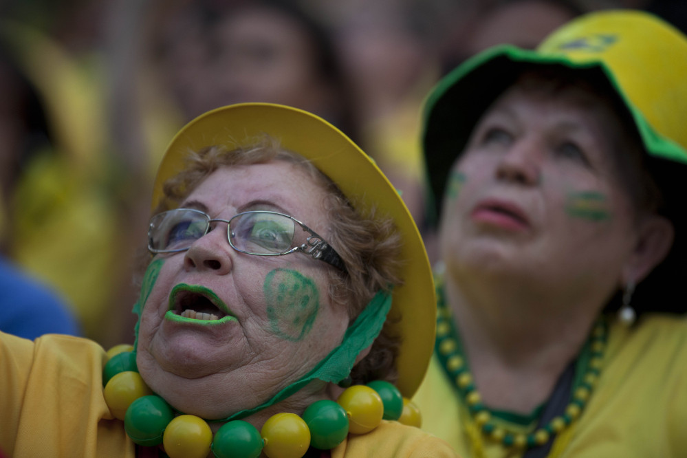 A fan of the Brazilian national soccer team watches the Mexico vs. Brazil match at the FIFA Fan Fest. Mexico claimed a well-deserved point against Brazil in a largely frustrating Group A game which finished 0-0 at Estadio Castelao in Fortaleza.