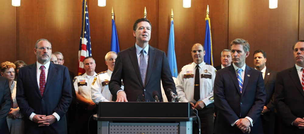FBI Director James Comey, backed by law enforcement personnel and prosecutors, said Tuesday the arrest of Ahmed Abu Khattala sends a message to others that “we will shrink the world to bring you to justice.”