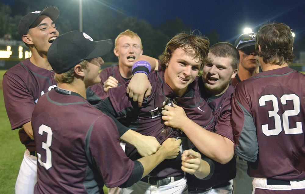 Windham pitcher Tanner Laberge is mobbed by teammates after pitching a no-hitter in the Western Maine Class A final Tuesday in Standish.