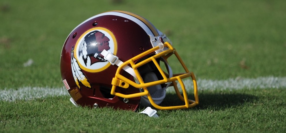 A Washington Redskins football helmet lies on the field during NFL football minicamp, Wednesday.
