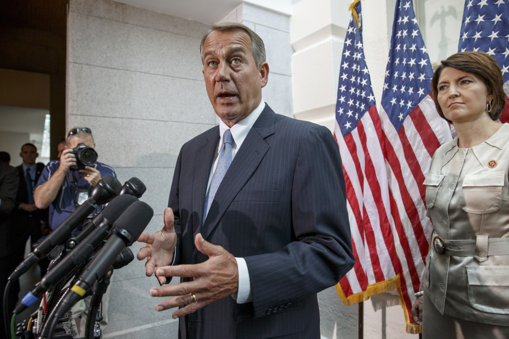 House Speaker John Boehner of Ohio, accompanied by Rep. Cathy McMorris Rodgers, R-Wash., tells reporters on Capitol Hill in Washington on Wednesday that the United States should not be talking to Iran about a joint effort to help the Iraqi government battle insurgents.