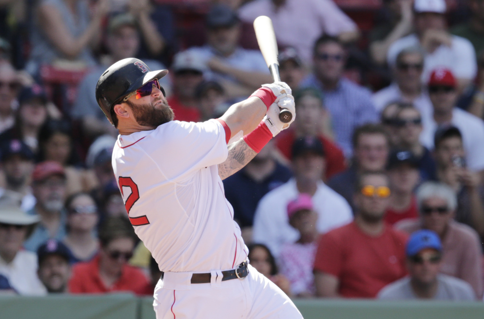 Boston Red Sox’s Mike Napoli watches the flight of his game-winning, walk off home run against the Minnesota Twins during the 10th inning of a baseball game at Fenway Park in Boston, Wednesday, June 18, 2014. The Red Sox won 2-1 in 10 innings.