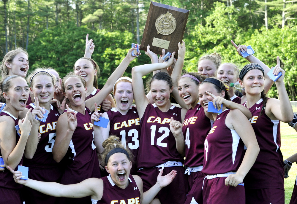 The Cape Elizabeth’s girls’ lacrosse team celebrates after edging Kennebunk 8-7 in overtime in the Western Class B final Wednesday at Cape Elizabeth.