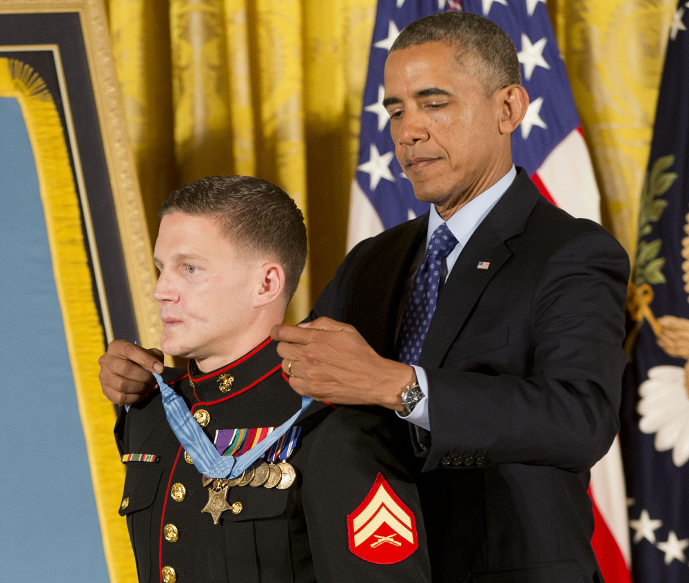President Barack Obama awards the Medal of Honor to retired Marine Cpl. William “Kyle” Carpenter, Thursday, June 19, 2014, in the East Room of the White House in Washington.