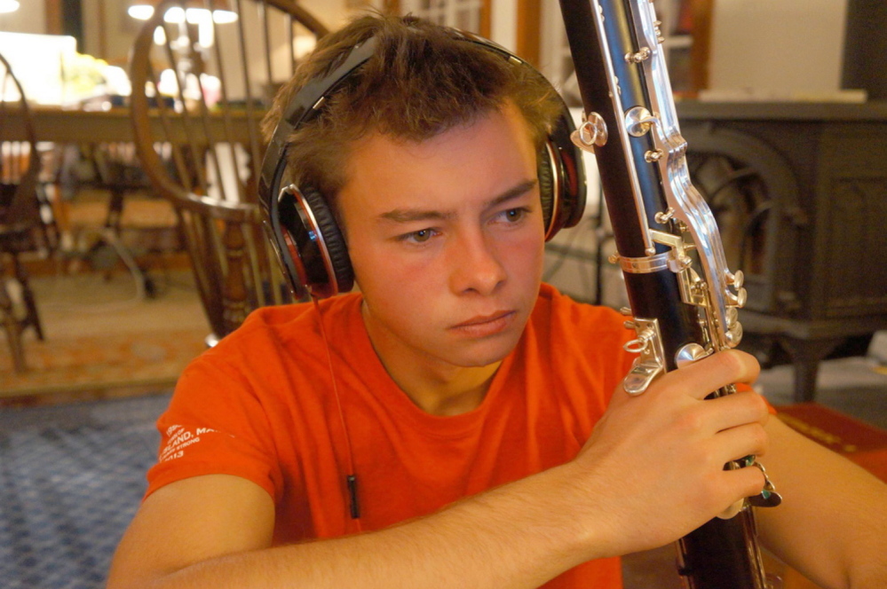 Benjamin Lamontagne, who planned to study music, holds his bass clarinet.