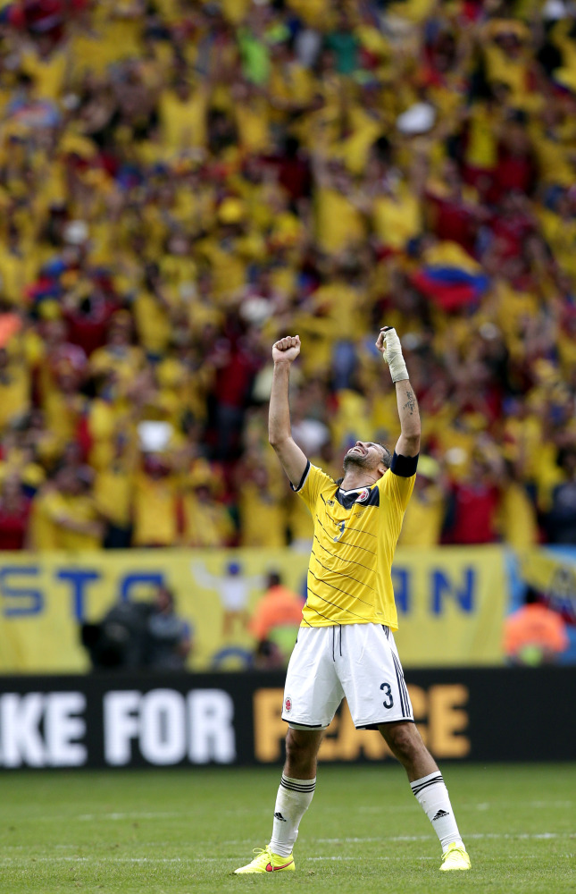 Colombia’s Mario Yepes celebrates after the group C World Cup soccer match between Colombia and Ivory Coast at the Estadio Nacional in Brasilia, Brazil, Thursday, June 19, 2014. Colombia won the match 2-1.