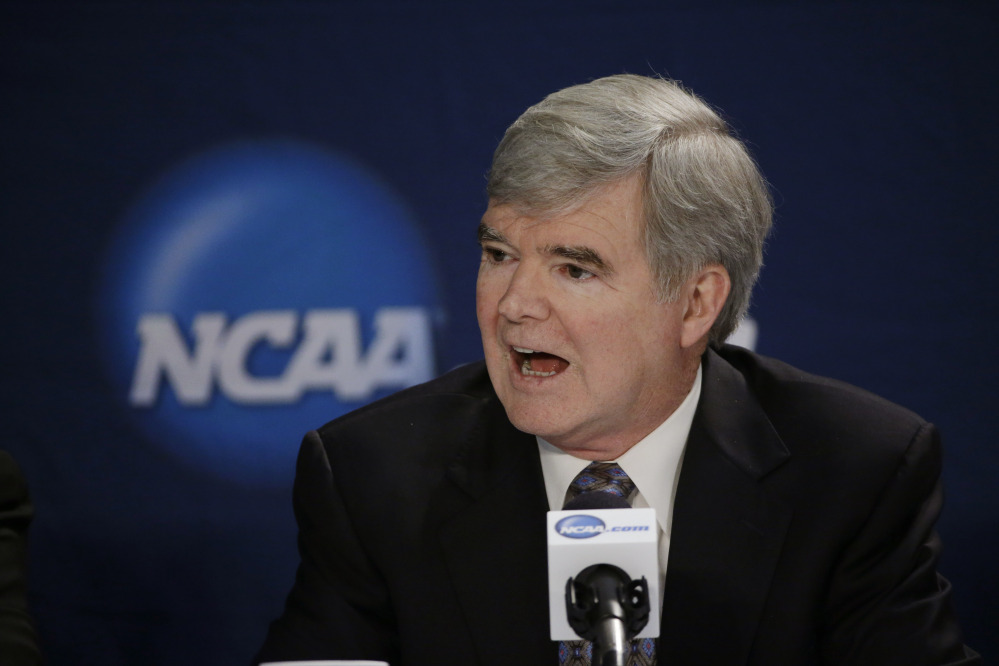 In this April 6, 2014 file photo, NCAA President Mark Emmert answers a question at a news conference in Arlington, Texas. Testifying in a landmark antitrust lawsuit filed against his organization, Emmert said Thursday, June 19, 2014, he believes there is a clear difference between the proposal to pay athletes a few thousand more dollars a year and giving them the equivalent of a salary.