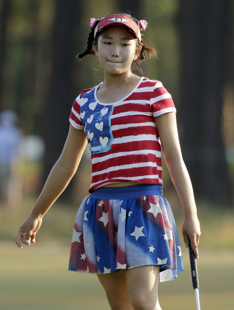 Lucy Li reacts to her putt on the 11th hole during the first round of the U.S. Women’s Open golf tournament in Pinehurst, N.C., Thursday, June 19, 2014.