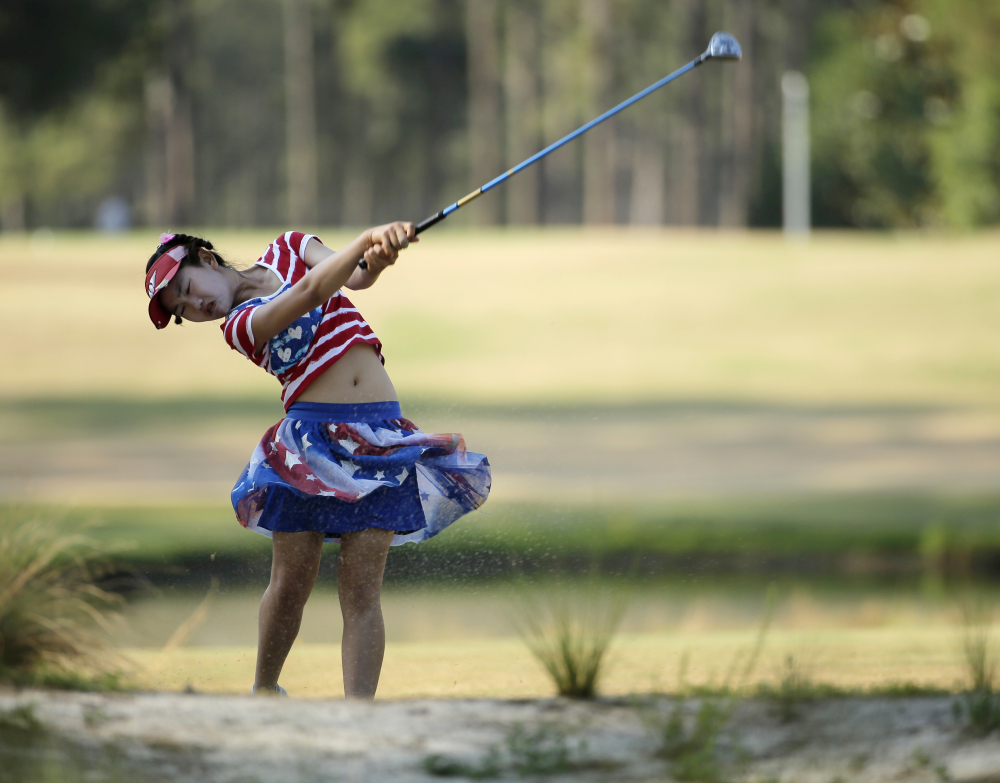 Lucy Li hits from a waste area on the 15th fairway during the first round of the U.S. Women’s Open golf tournament in Pinehurst, N.C., Thursday, June 19, 2014.