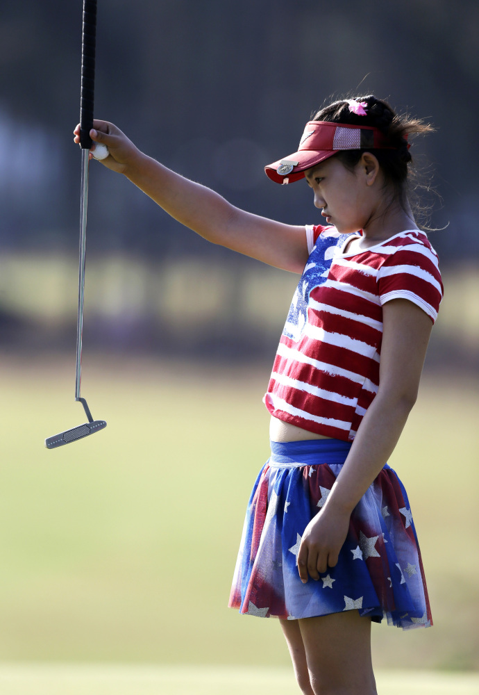 Lucy Li lines up a putt on the 13th hole during the first round of the U.S. Women’s Open golf tournament in Pinehurst, N.C., Thursday, June 19, 2014.
