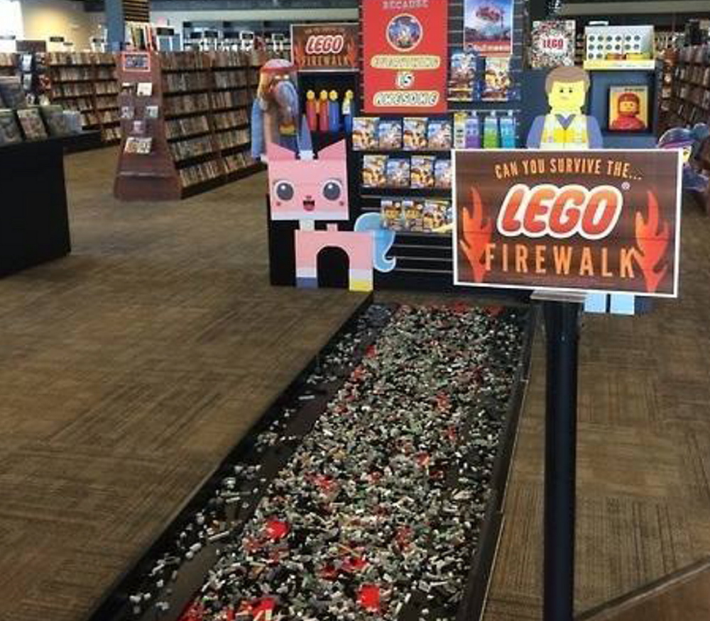 Customers at Bull Moose in South Portland earned a discount on “The Lego Movie” DVD if they could scoot barefoot across the “fire walk” of Lego pieces Tuesday.