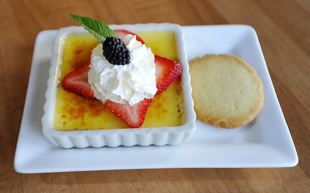 Vanilla creme brulee with Meyer lemon shortbread cookie and berry garnish.