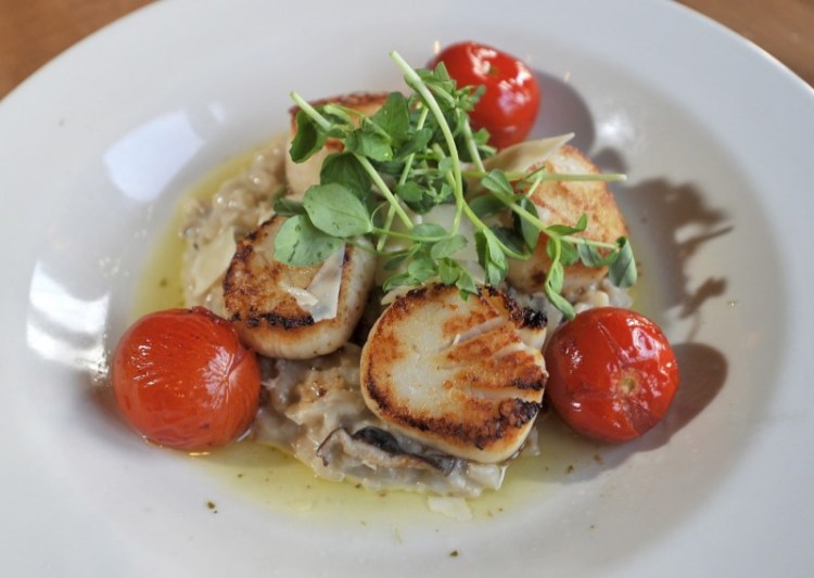 Diver scallops with mushroom-baby spinach risotto, roasted cherry tomatoes and white truffle-oregano vinaigrette.